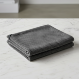 Grey textured towel on a marble surface