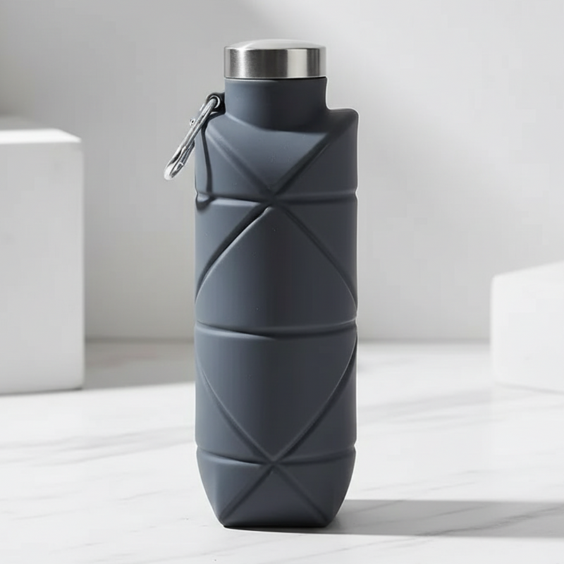 Dark gray water bottle with geometric pattern on a light surface