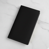 Black notebook on a marble surface