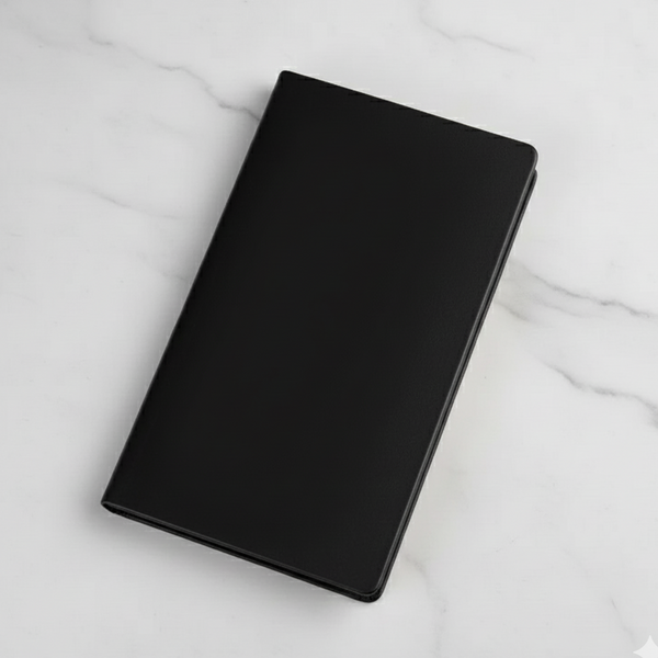 Black notebook on a marble surface
