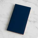Blue notebook on a marble surface