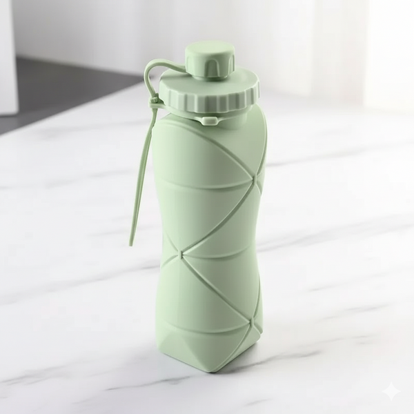 Collapsible green water bottle on a white surface