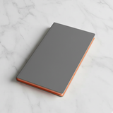 Grey notebook with copper edge on a marble surface