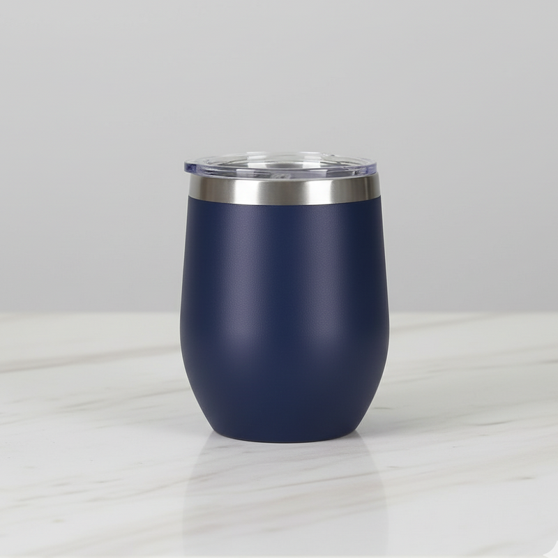 Navy blue tumbler with silver lid on a light grey background
