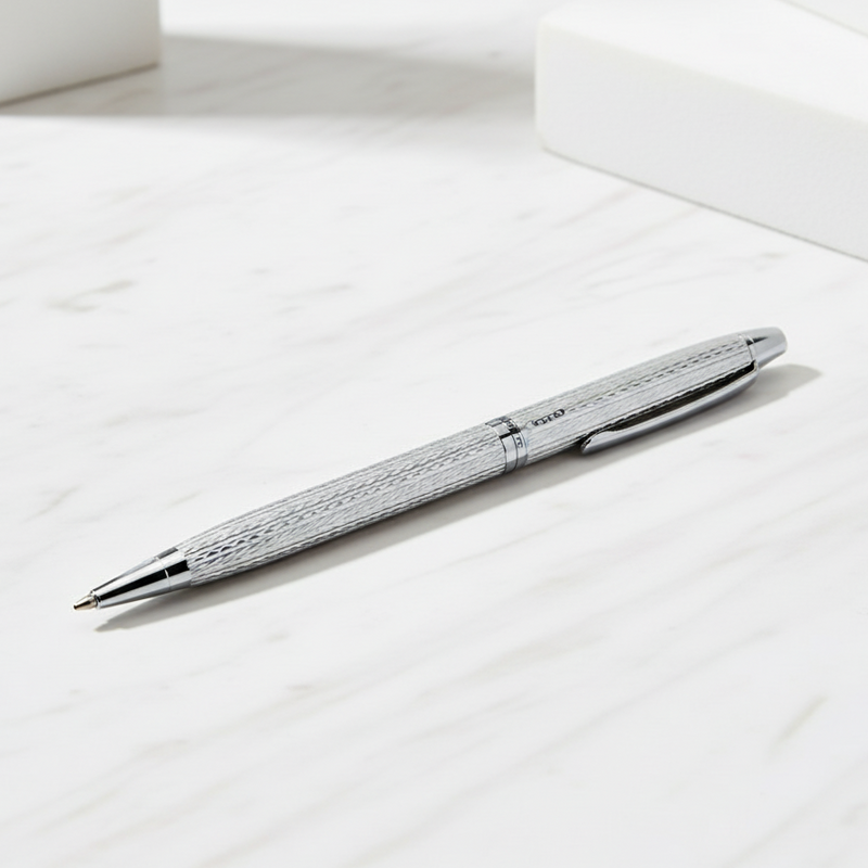 Silver pen on a white surface